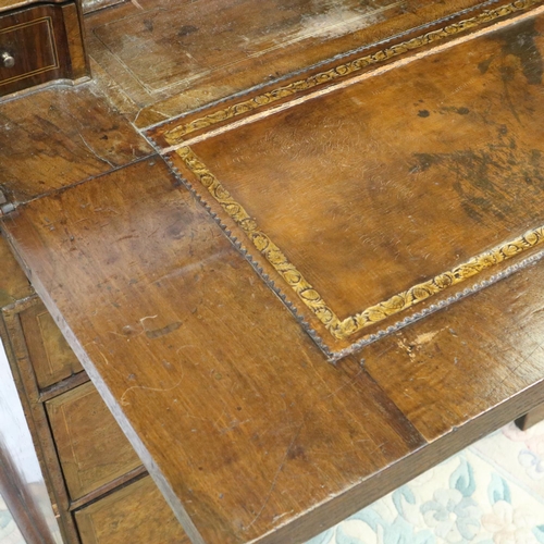 2147 - *KEYS IN OFFICE* An early 18th century walnut bureau, with stepped fitted interior, two short above ... 