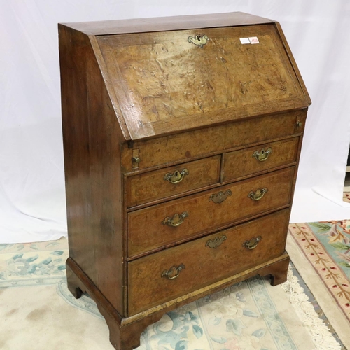 2147 - *KEYS IN OFFICE* An early 18th century walnut bureau, with stepped fitted interior, two short above ... 