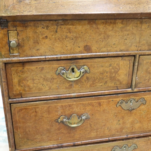 2147 - *KEYS IN OFFICE* An early 18th century walnut bureau, with stepped fitted interior, two short above ... 