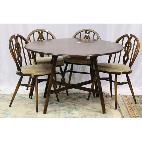 2148 - Ercol dark elm dining suite comprising circular drop leaf table and four chairs, one chair with dama... 