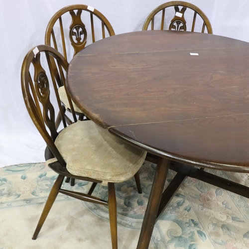 2148 - Ercol dark elm dining suite comprising circular drop leaf table and four chairs, one chair with dama... 