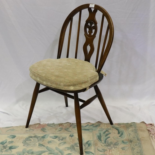 2148 - Ercol dark elm dining suite comprising circular drop leaf table and four chairs, one chair with dama... 