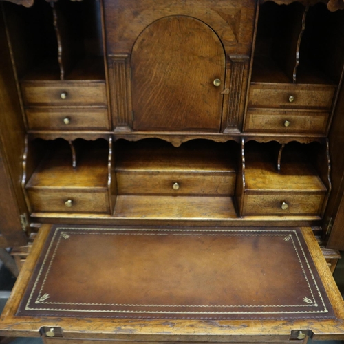 2169 - 20th century fitted writing desk by Tudor Oak having two arched doors above three long drawers, 89 x... 