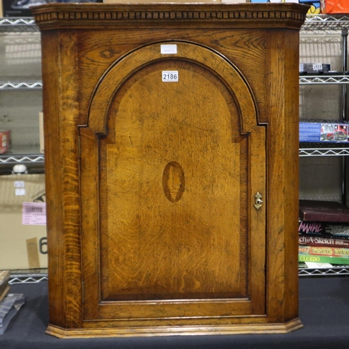 2186 - Panelled single door oak corner cupboard, W: 69 cm, H: 82 cm. Not available for in-house P&P