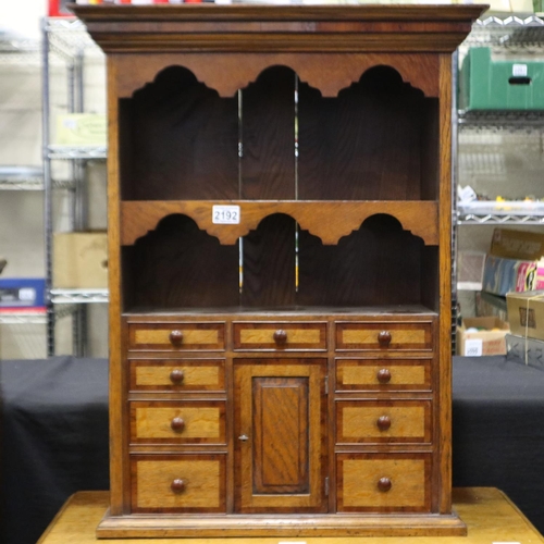 2192 - A crossbanded oak wall-mounting spice cabinet, comprising drawers and locking cupboard, 60 x 26 x 78... 