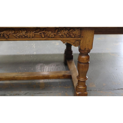 2196 - Substantial oak extending dining table, the frieze carved with designs of acorns in the Tudor manner... 