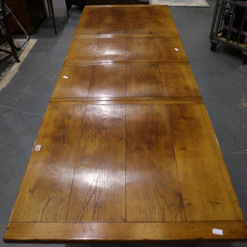 2196 - Substantial oak extending dining table, the frieze carved with designs of acorns in the Tudor manner... 