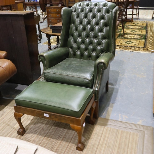 2201 - An Oxford green Chesterfield wing-back fireside chair, with later associated footstool. Not availabl... 