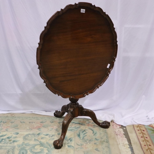 2206 - A 20th century mahogany mahogany table, raised on a carved tripod base with twist support, hinged to... 