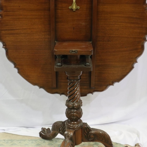 2206 - A 20th century mahogany mahogany table, raised on a carved tripod base with twist support, hinged to... 