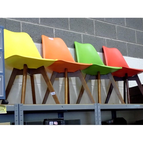 1706 - Four plastic chairs, with darkwood squared legs, seat pads in red, orange, yellow and green. Not ava... 