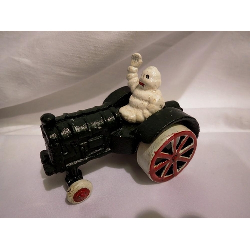 1009A - Cast iron Michelin Man on tractor. UK P&P Group 1 (£16+VAT for the first lot and £2+VAT for subseque... 