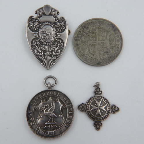 121 - Three hallmarked silver award fobs, including St Johns Ambulance, combined 36g, and a 1931 silver ha... 