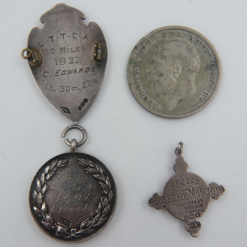 121 - Three hallmarked silver award fobs, including St Johns Ambulance, combined 36g, and a 1931 silver ha... 