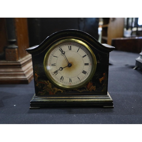 328 - Mechanical clock in an ebonised case, H: 15cm. Not available for in-house P&P