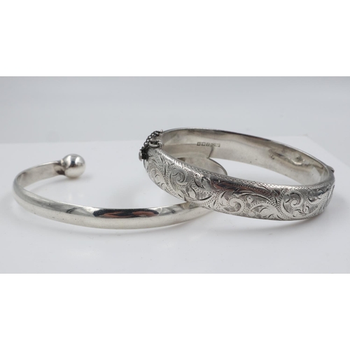 37 - Hallmarked silver snap bangle with engraved decoration, and a 925 silver torq bangle, 53g. UK P&P Gr... 