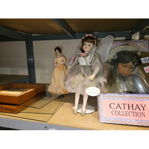 1030 - Three large dolls and a display case. Not available for in-house P&P