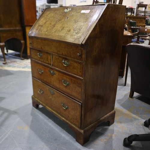 2147 - *KEYS IN OFFICE* An early 18th century walnut bureau, with stepped fitted interior, two short above ... 