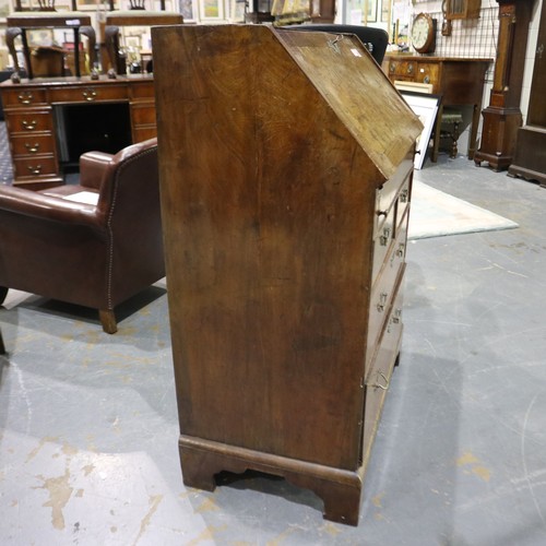 2147 - *KEYS IN OFFICE* An early 18th century walnut bureau, with stepped fitted interior, two short above ... 