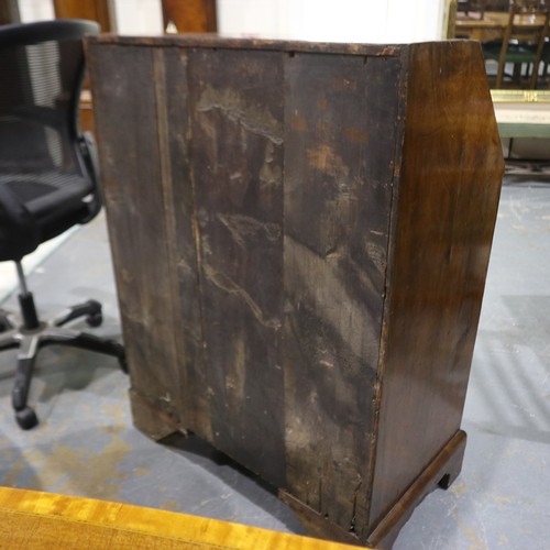 2147 - *KEYS IN OFFICE* An early 18th century walnut bureau, with stepped fitted interior, two short above ... 