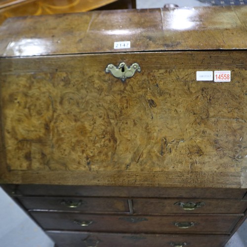 2147 - *KEYS IN OFFICE* An early 18th century walnut bureau, with stepped fitted interior, two short above ... 