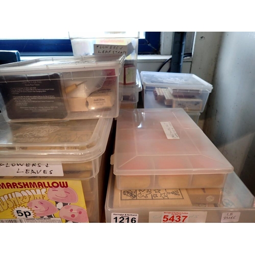 1216 - Eight plastic containers of wooden block stamps. Not available for in-house P&P