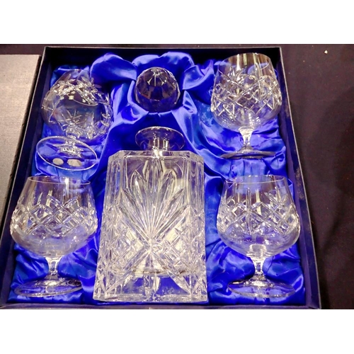 1282 - Bohemian crystal decanter and four glasses, in original box. Not available for in-house P&P