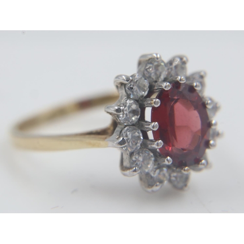 21 - 9ct gold, garnet and cubic zirconia set cocktail ring, size O, 2.9g. UK P&P Group 0 (£6+VAT for the ... 