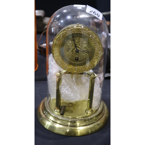 260 - Brass Anniversary clock with a figural dial, beneath a glass dome. Not available for in-house P&P