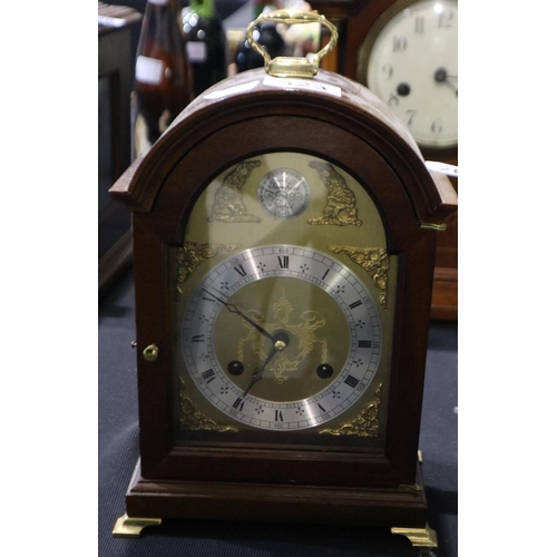 267 - Mahogany cased chiming mantel clock raised on brass bracket feet, H: 26cm. Not available for in hous... 