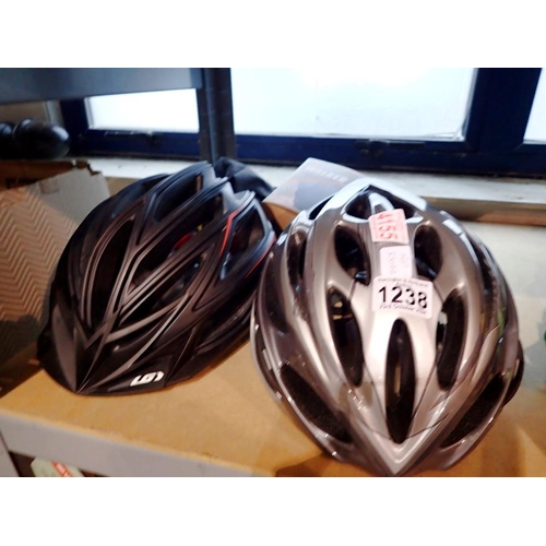 1238 - Two cycle helmets, Garneau and Giro, with a boxed pair of Yaktrax walker snow overshoes. Not availab... 