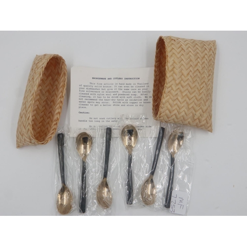 130 - Set of six bronze teaspoons, with inlaid wooden handles, made in Thailand, in a wicker case, each st... 