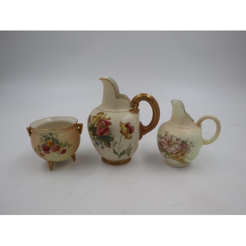 259 - Three pieces of Royal Worcester Blush Ivory ware, two flat back jugs and a small twin handled pot on... 