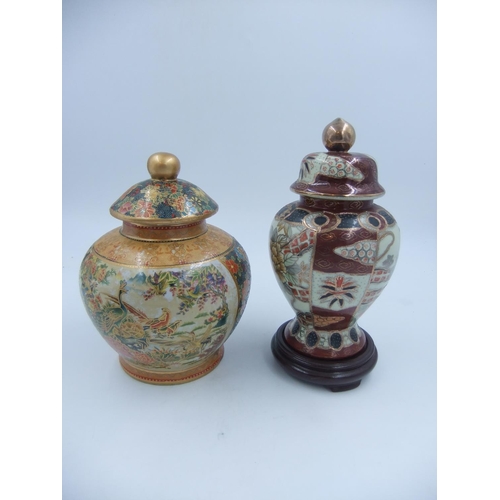 307 - Two Oriental temple jars one with floral decorated panels and one decorated with Asiatic pheasants, ... 