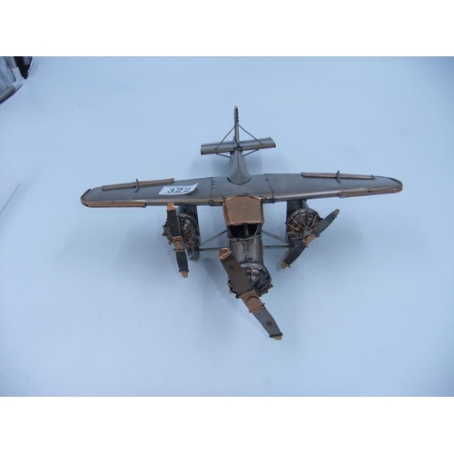 322 - Tin plate three engine plane. H: 9cm. UK P&P Group 2 (£20+VAT for the first lot and £4+VAT for subse... 