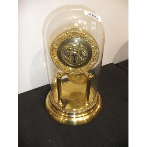 332 - Brass Anniversary clock with a figural dial, beneath a glass dome. Not available for in-house P&P