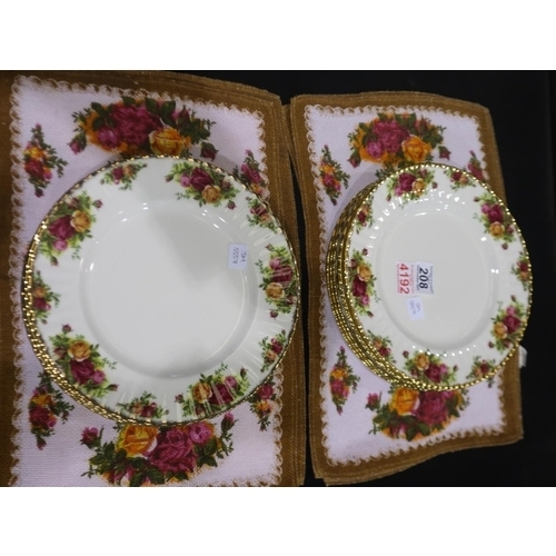 208 - Eleven Royal Albert dinner plates in the Old Country Roses pattern and a set of six fabric place mat... 