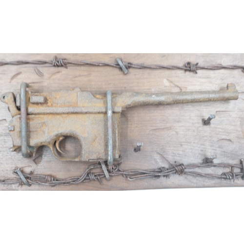 2188 - Relic Imperial German WWI Mauser C96 semi-automatic pistol, later mounted on a panel with barbed wir... 