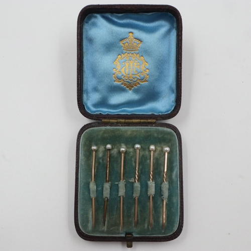 46 - Two sets of three unmarked gold stick pins, pearl-set, combined 2.4g, within a fitted case. UK P&P G... 