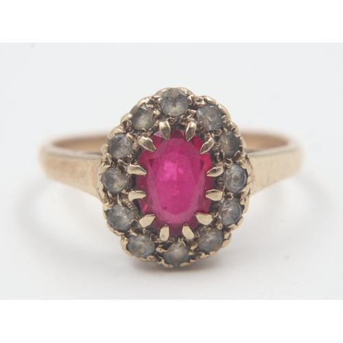 64 - 9ct gold stone-set cocktail ring, with a ruby surrounded by cubic zirconia, size M, 2.3g. UK P&P Gro... 