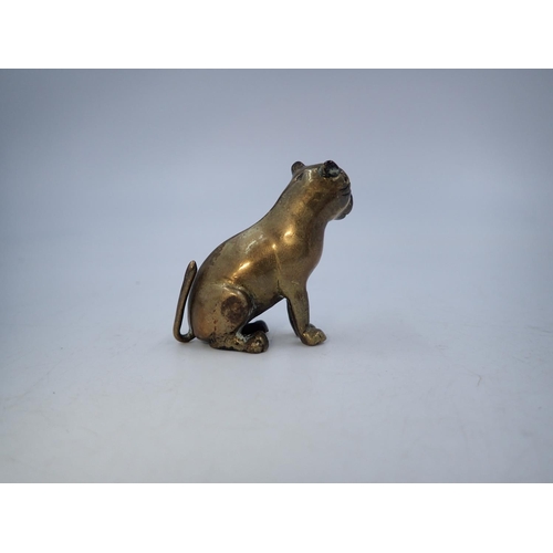 103 - Small brass seated dog. H: 4cm. UK P&P Group 1 (£16+VAT for the first lot and £2+VAT for subsequent ... 