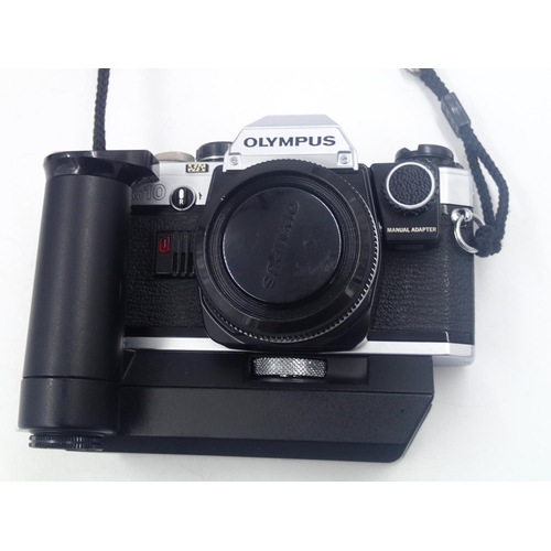 144 - Cased Olympus CM10 35mm camera, with additional lenses, including a Sirius 28-200mm lens. UK P&P Gro... 