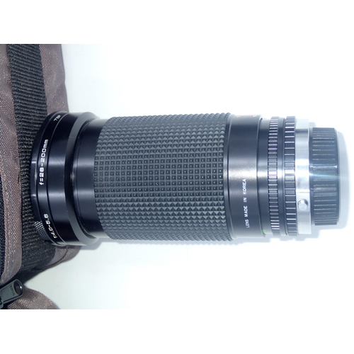 144 - Cased Olympus CM10 35mm camera, with additional lenses, including a Sirius 28-200mm lens. UK P&P Gro... 