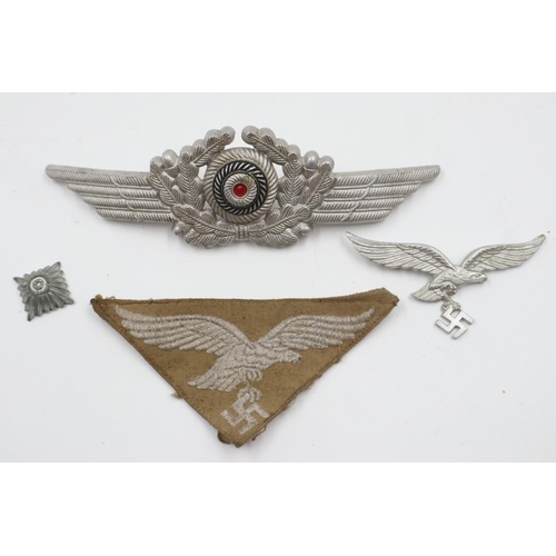 103 - German WWII Luftwaffe: visor cap eagle (lacking pin) and cockade, with an embroidered tropical breas... 