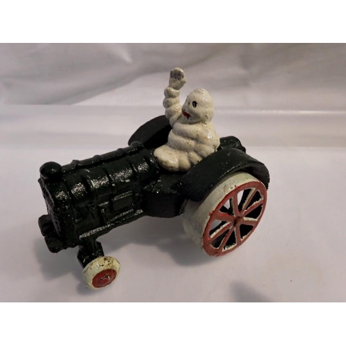 1062 - Cast iron Michelin Man on a tractor, H: 80 mm. UK P&P Group 1 (£16+VAT for the first lot and £2+VAT ... 