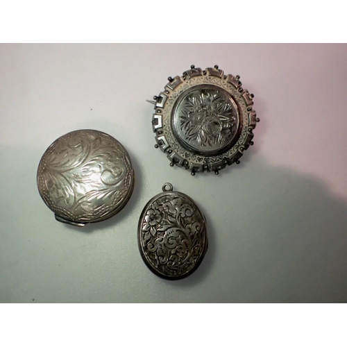 1073 - Victorian silver mourning brooch, silver locket and a silver pill box containing a faceted garnet. U... 