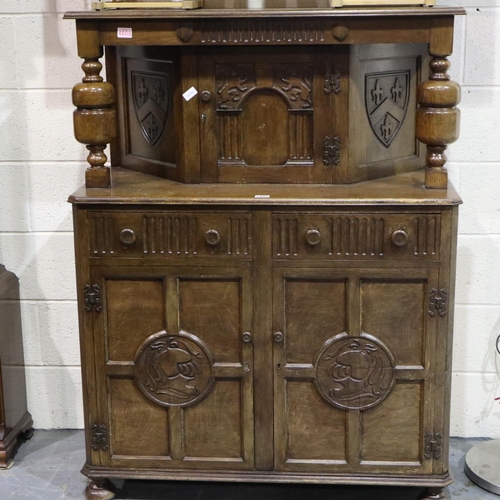 2105 - Jaycee carved oak court cupboard, two doors and two drawers to the lower section and single door to ... 