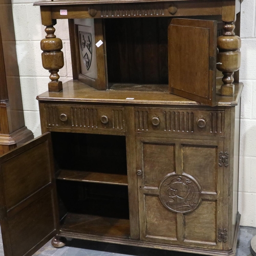 2105 - Jaycee carved oak court cupboard, two doors and two drawers to the lower section and single door to ... 