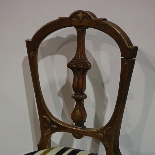 2132 - An Edwardian fireside elbow chair, with inlaid walnut frame and contemporary upholstery, with a furt... 