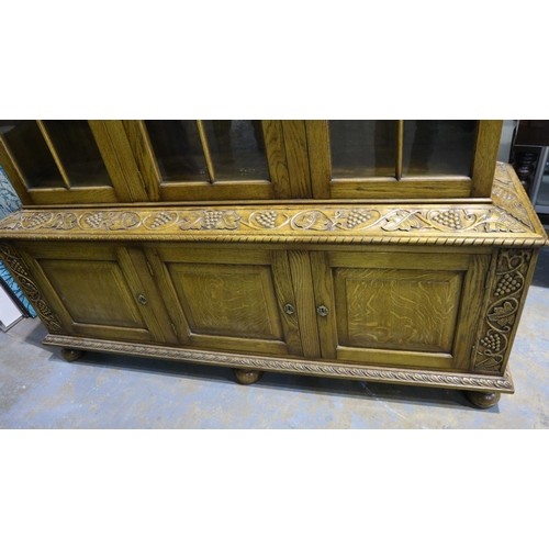 2136 - Substantial oak glazed bookcase with cupboards below and grapevine carved decoration, 160 x 45 x 185... 